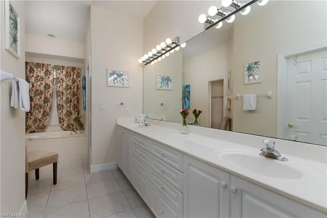 a bathroom with a double vanity sink and a mirror