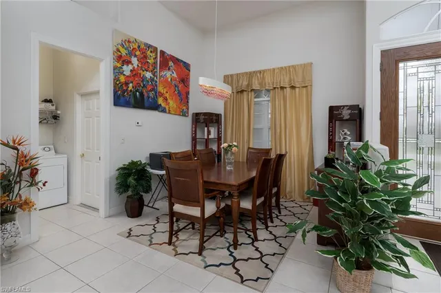 a view of a dining room with furniture and a potted plant