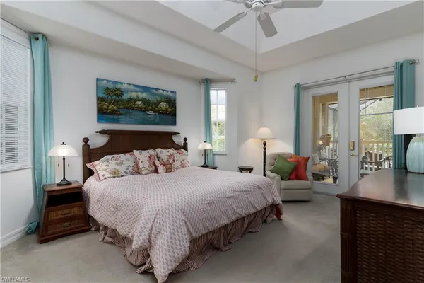 a bedroom with bed and a chandelier