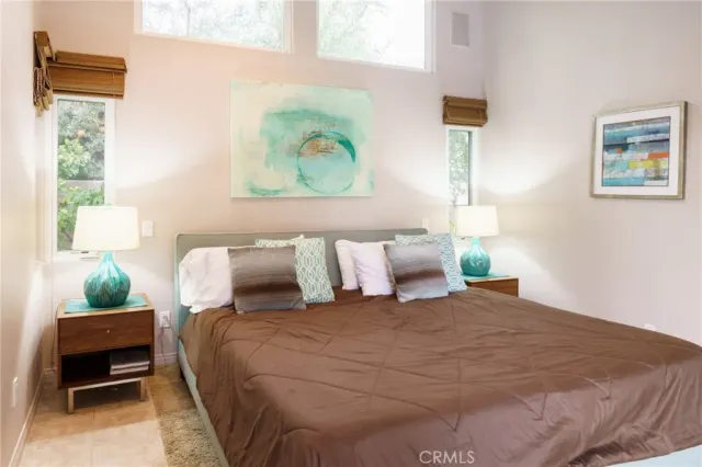 a bedroom with a bed and a painting on the wall