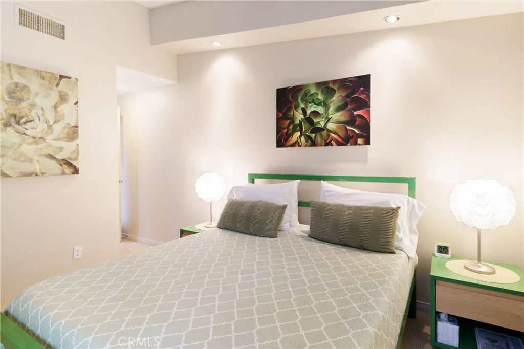 1134 Abrigo Road Palm Springs, CA 92262 - Photo 6 of 12 a bedroom with a bed and a lamp on dresser