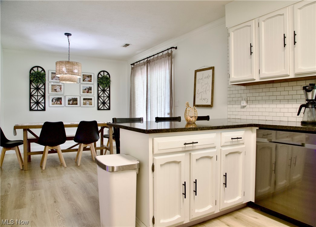 444 Eyermann Road Belpre, OH 45714 - Photo 8 of 16 Kitchen with white cabinets, dishwasher, decorative light fixtures, and light hardwood / wood-style floors