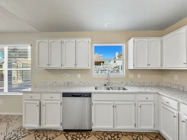 a kitchen with stainless steel appliances granite countertop a sink and cabinets