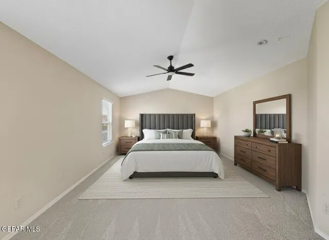 a spacious bedroom with a bed and a chandelier