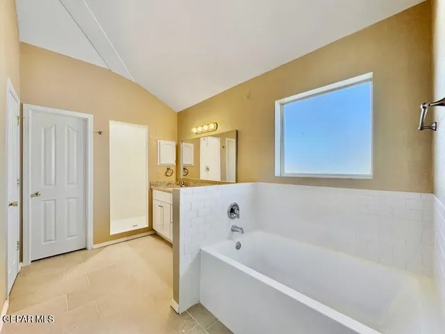 a bathroom with a bathtub and a shower