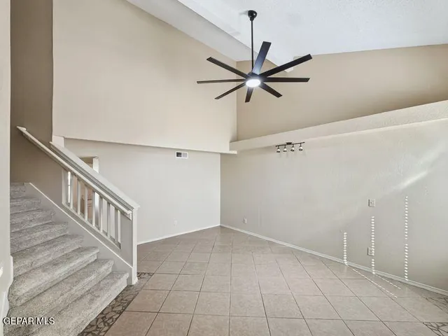 a view of a hallway with a ceiling fan