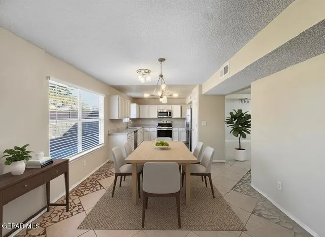 a dining room with furniture and window