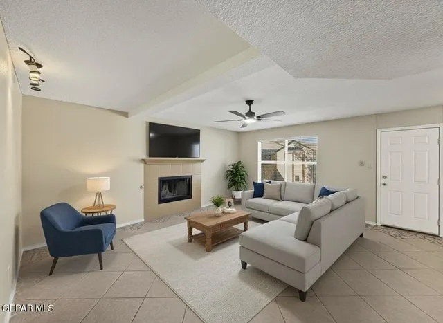 a living room with furniture a fireplace and a flat screen tv