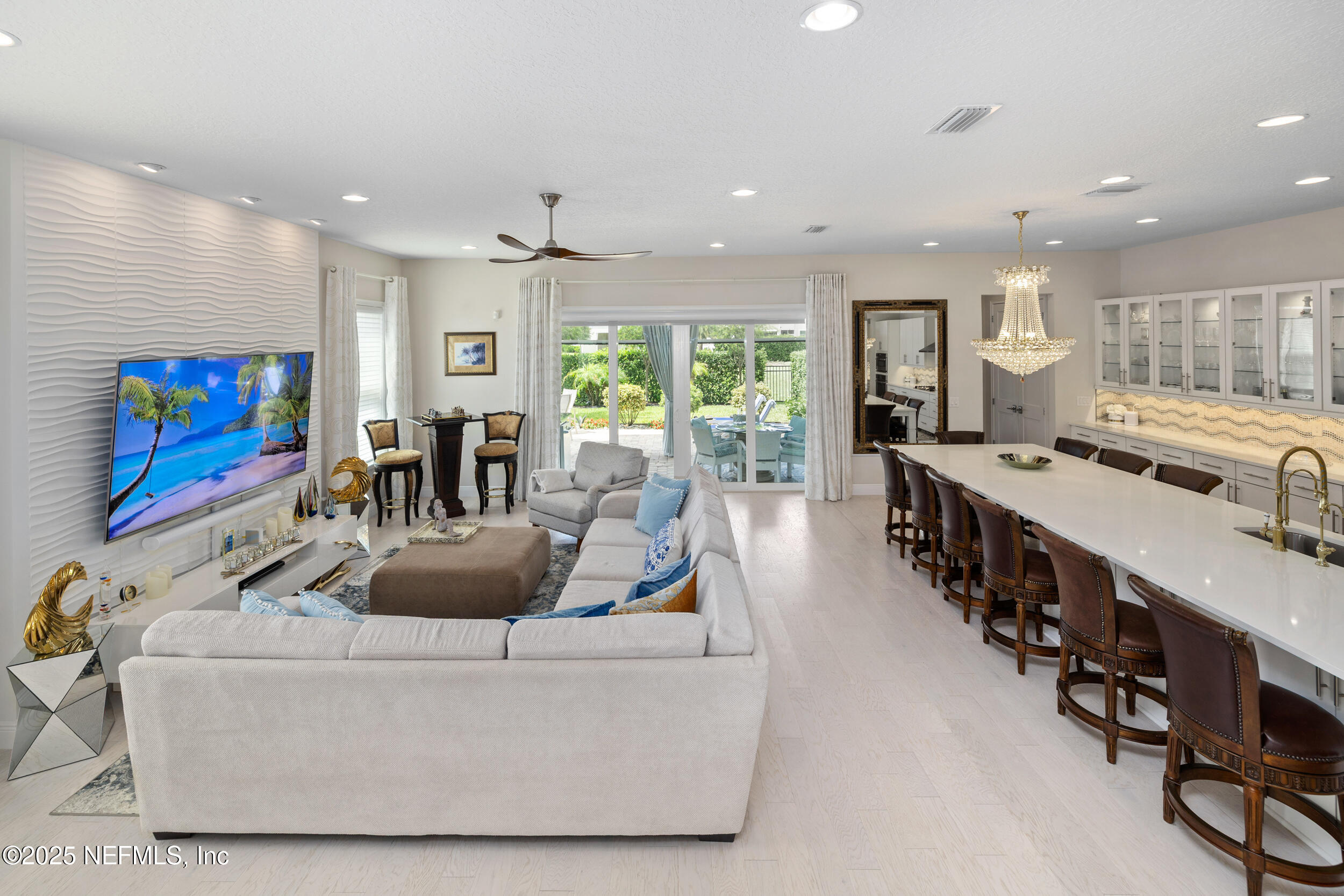 651 Rum Runner Way St. Johns, FL 32259 - Photo 27 of 97 a living room with large furniture a flat screen tv and a large window