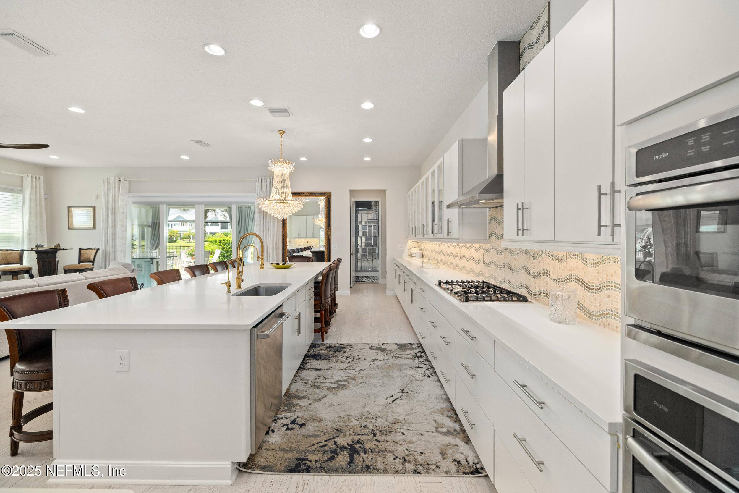 651 Rum Runner Way St. Johns, FL 32259 - Photo 30 of 97 a large white kitchen with wooden floor and stainless steel appliances