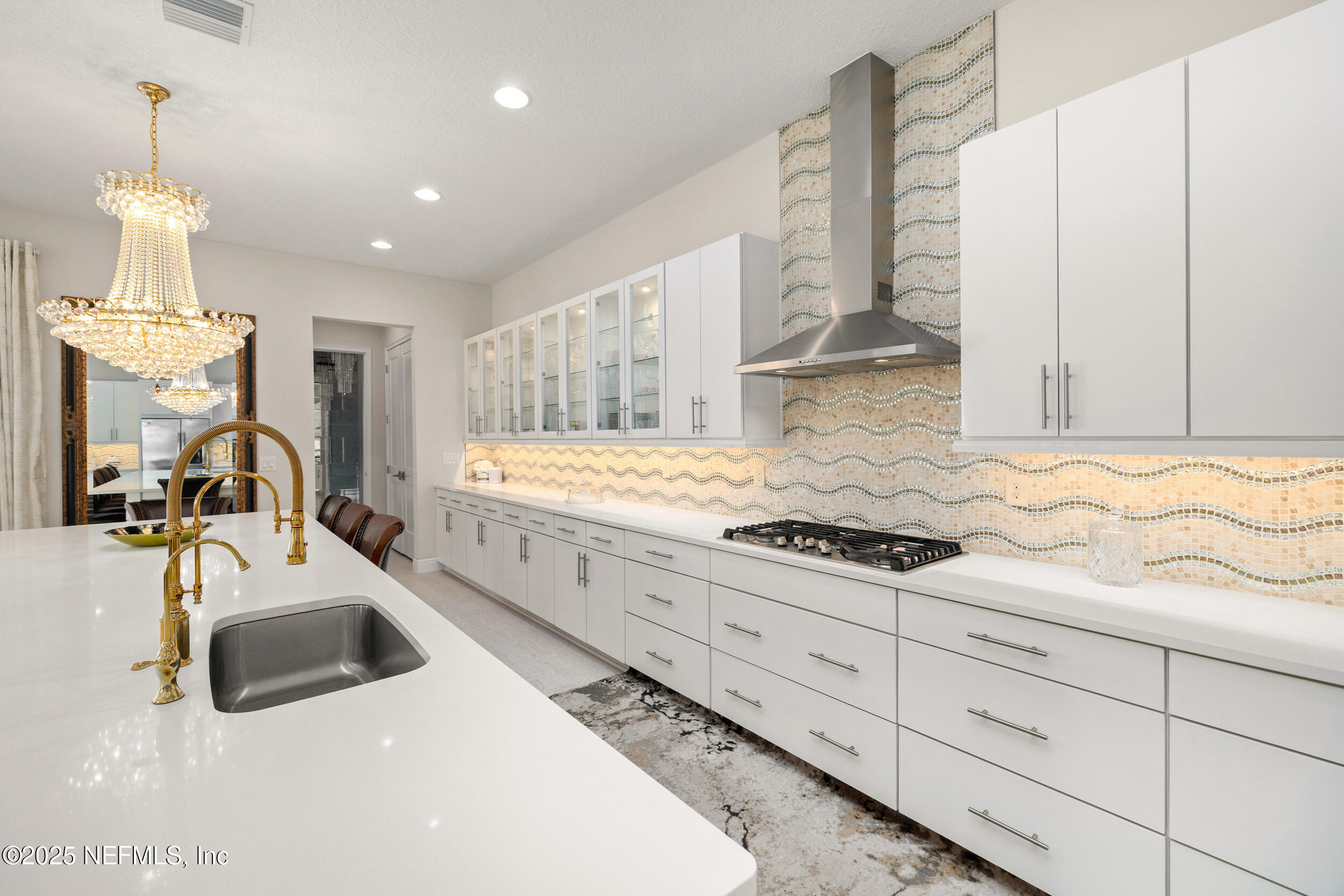 651 Rum Runner Way St. Johns, FL 32259 - Photo 31 of 97 a kitchen with granite countertop a sink stainless steel appliances and cabinets