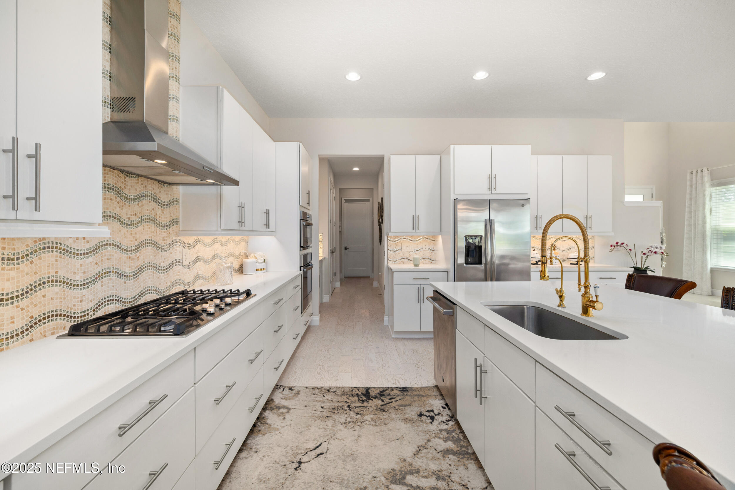 651 Rum Runner Way St. Johns, FL 32259 - Photo 32 of 97 a large kitchen with stainless steel appliances granite countertop a sink and cabinets