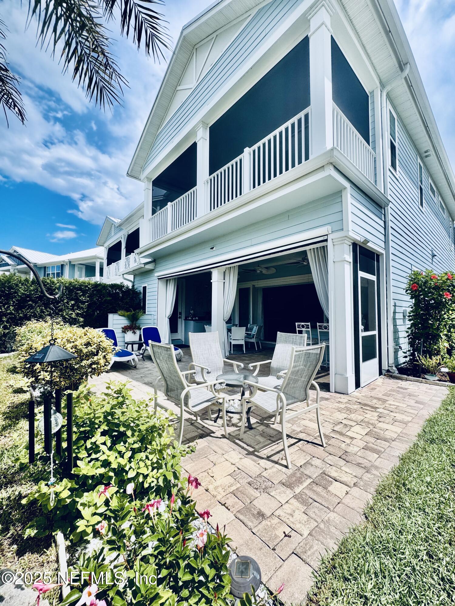 651 Rum Runner Way St. Johns, FL 32259 - Photo 67 of 97 a view of a patio with table and chairs potted plants and large tree