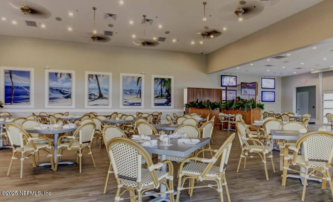 651 Rum Runner Way St. Johns, FL 32259 - Photo 94 of 97 a view of a dining room with furniture and wooden floor