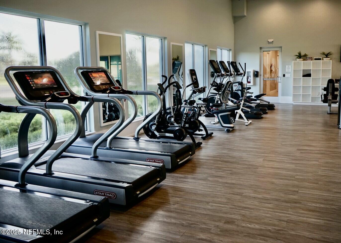 651 Rum Runner Way St. Johns, FL 32259 - Photo 97 of 97 a room with gym equipment and wooden floor