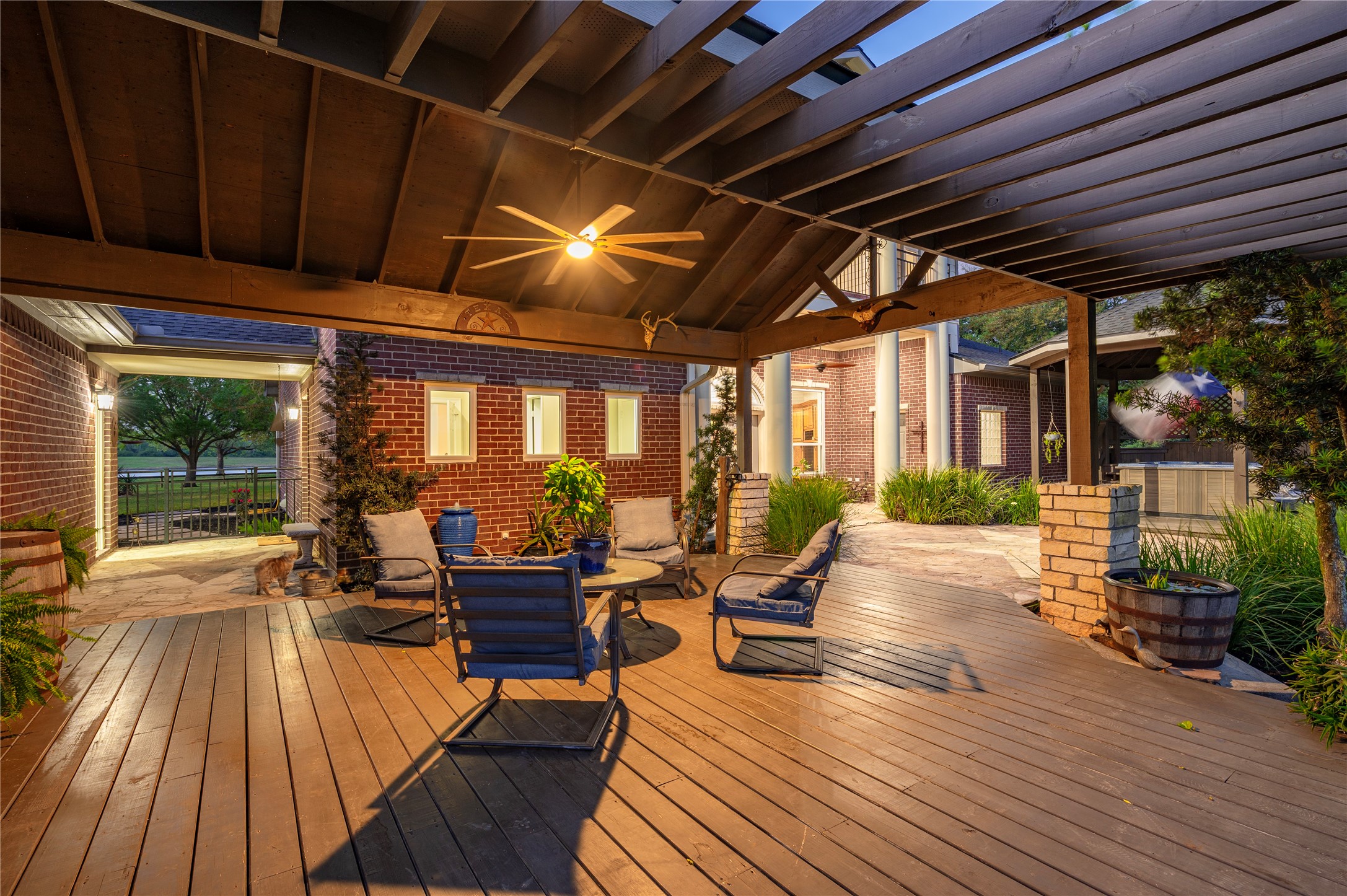 8211 Deats Lane Dickinson, TX 77539 - Photo 11 of 50 Inviting outdoor entertainment area with a covered patio, extensive decking, ceiling fan, exterior lighting and peaceful countryside views.
