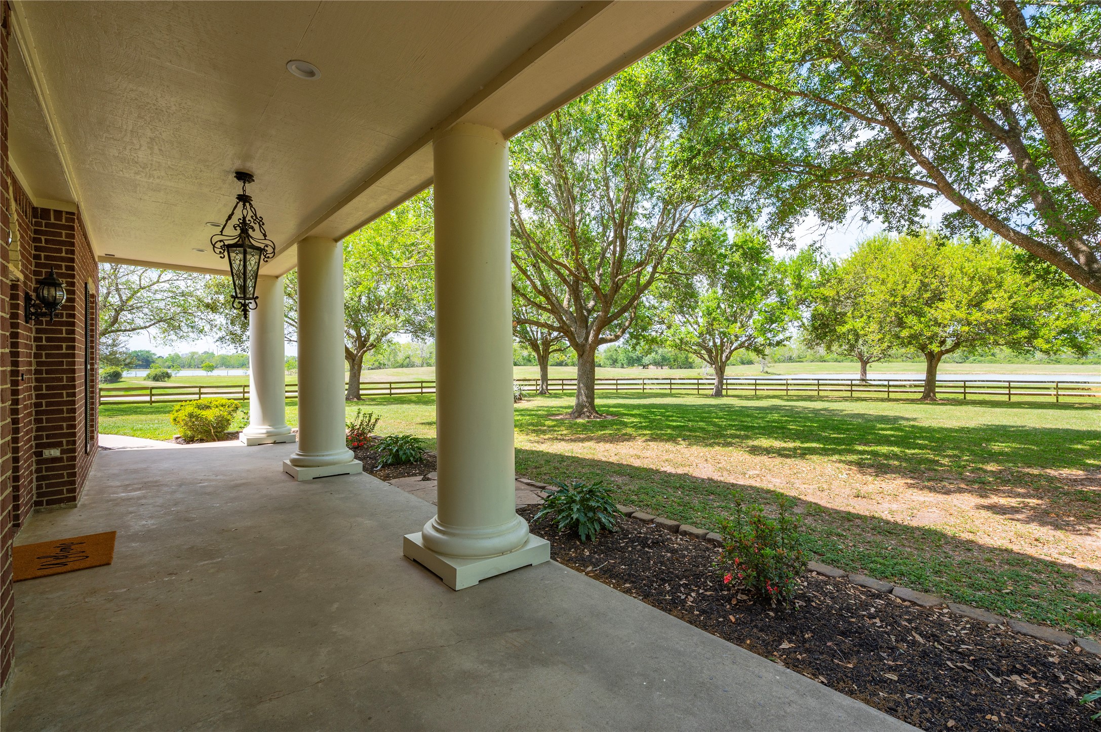 8211 Deats Lane Dickinson, TX 77539 - Photo 19 of 50 The inviting 60-foot covered front porch entrance makes the property ideal for hosting events, relaxing, or enjoying nature, with a focus on both aesthetics and functionality.