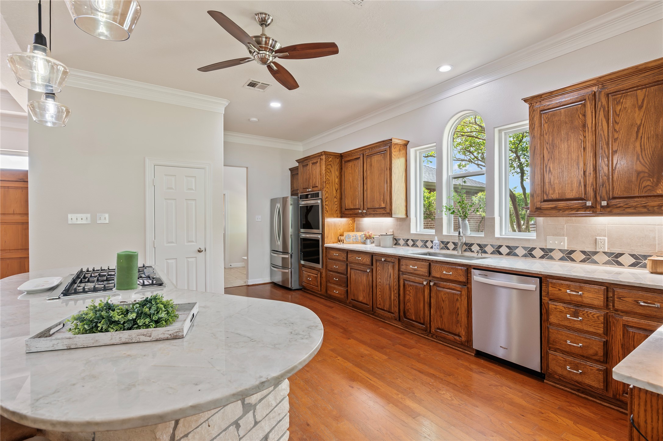 8211 Deats Lane Dickinson, TX 77539 - Photo 24 of 50 a large kitchen with kitchen island granite countertop a sink and a stove
