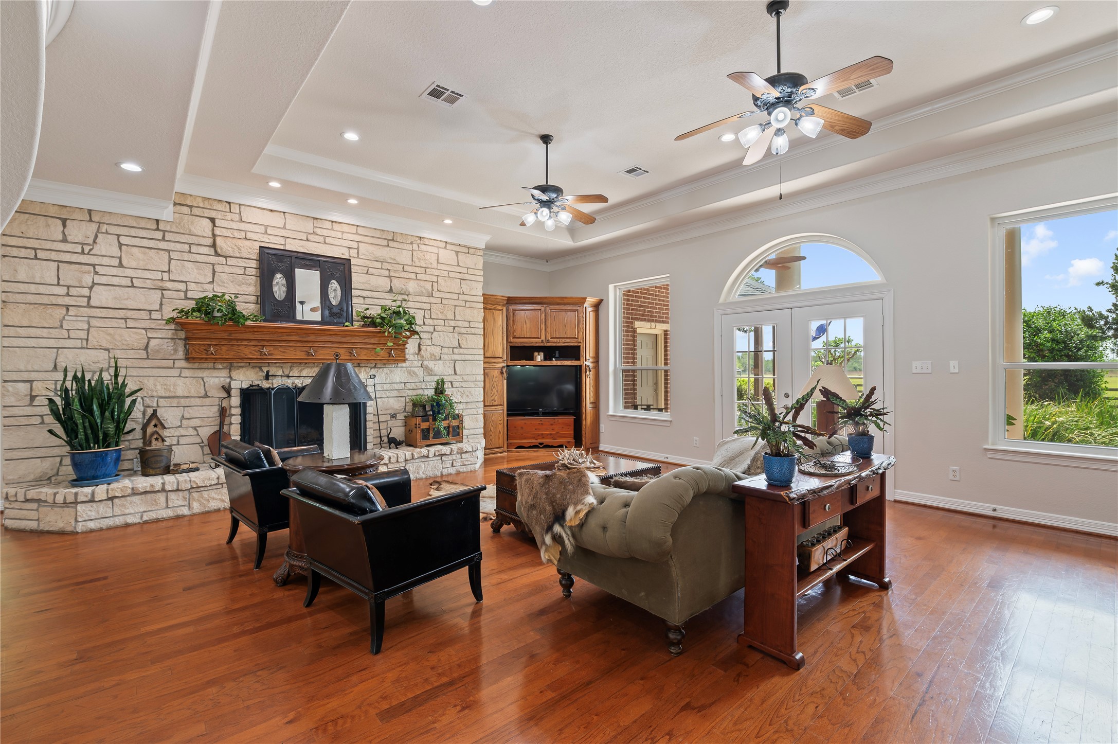 8211 Deats Lane Dickinson, TX 77539 - Photo 26 of 50 a living room with furniture a fireplace and a chandelier