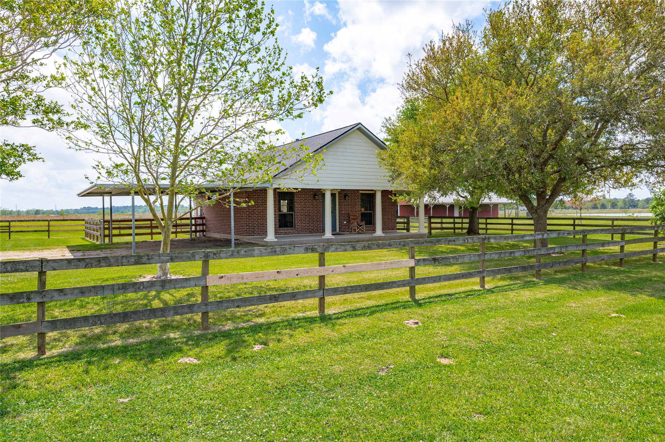 8211 Deats Lane Dickinson, TX 77539 - Photo 43 of 50 Newly remodeled guest home offering a spacious covered front porch that spans the length of the home, showcasing serene lake views. 3-car carport and fully fenced for pets or children.