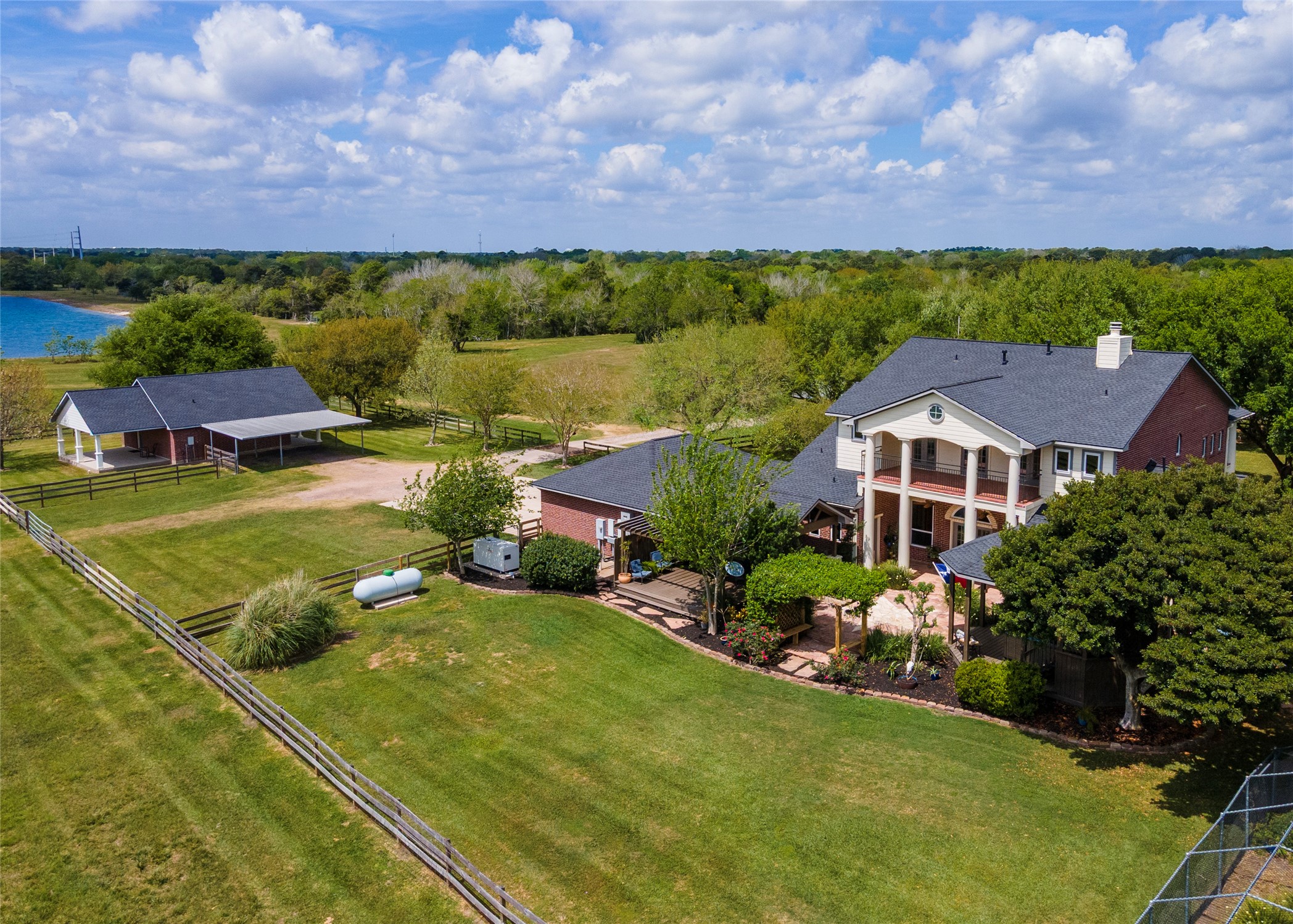 8211 Deats Lane Dickinson, TX 77539 - Photo 7 of 50 The grounds are equally impressive. The fully fenced backyard of the main residence is ideal for both relaxation and entertaining, featuring a covered patio, extensive decking, and a relaxing hot tub-perfect for hosting gatherings or enjoying quiet evenings under the stars. Self sustaining features include generator, propane, water well, septic system & green house structure too.