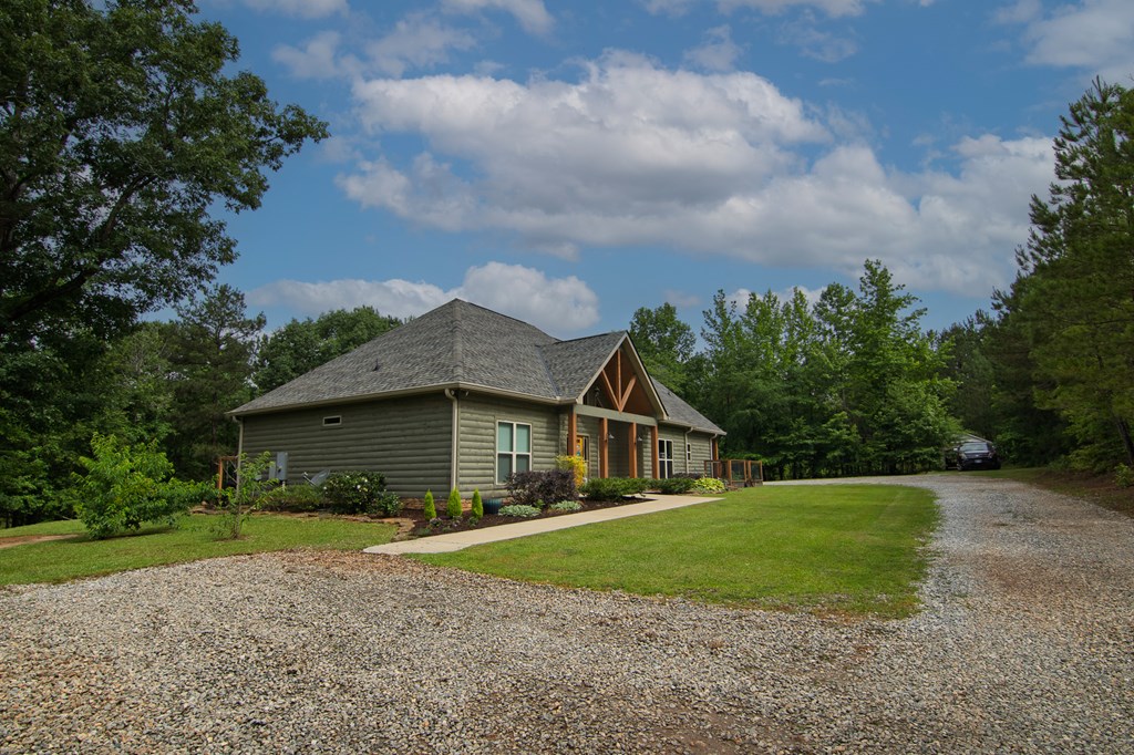 299 Savior Lane Hamilton, GA 31811 - Photo 65 of 92 a view of house in front of a big yard with plants and large trees