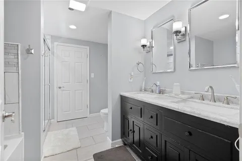 a en suite bathroom with a tub sink and mirror