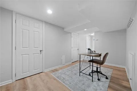 a bathroom with a toilet a sink and mirror