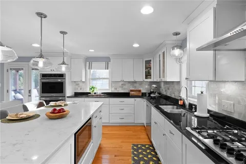 a kitchen with stainless steel appliances granite countertop a sink stove and refrigerator