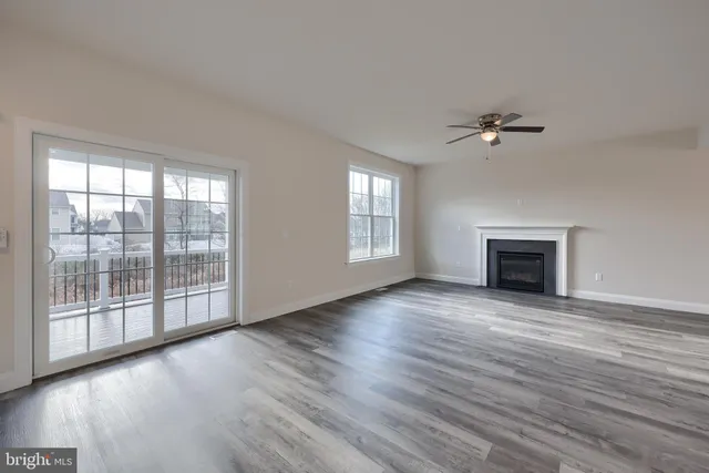 wooden floor chandelier and windows in an empty room