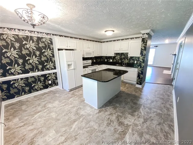 a kitchen with a sink and refrigerator