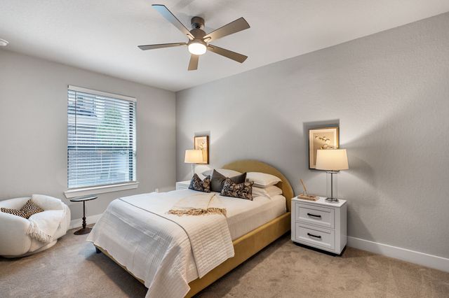 a bathroom with a bathtub shower sink mirror and toilet