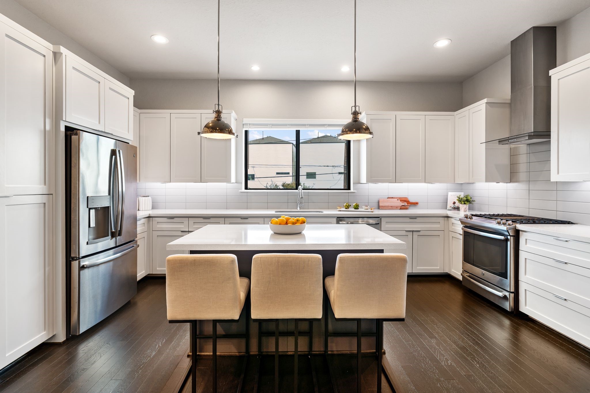 4219 Allen Street Houston, TX 77007 - Photo 28 of 29 a kitchen with stainless steel appliances granite countertop a dining table chairs refrigerator sink and microwave