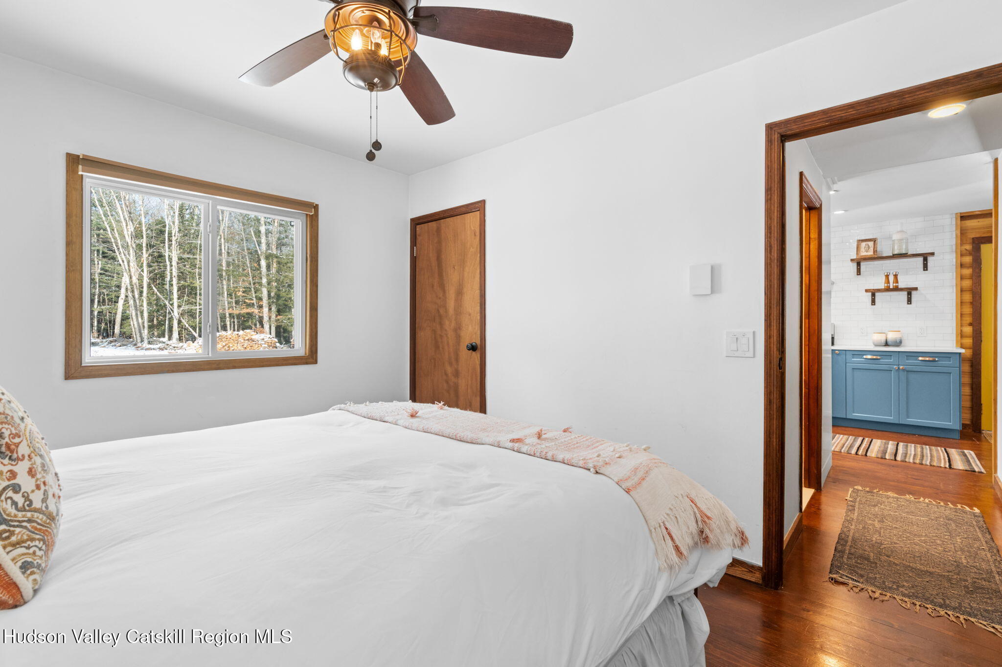 153 Slater Road Windham, NY 12454 - Photo 17 of 38 a bedroom with a bed and wooden floor