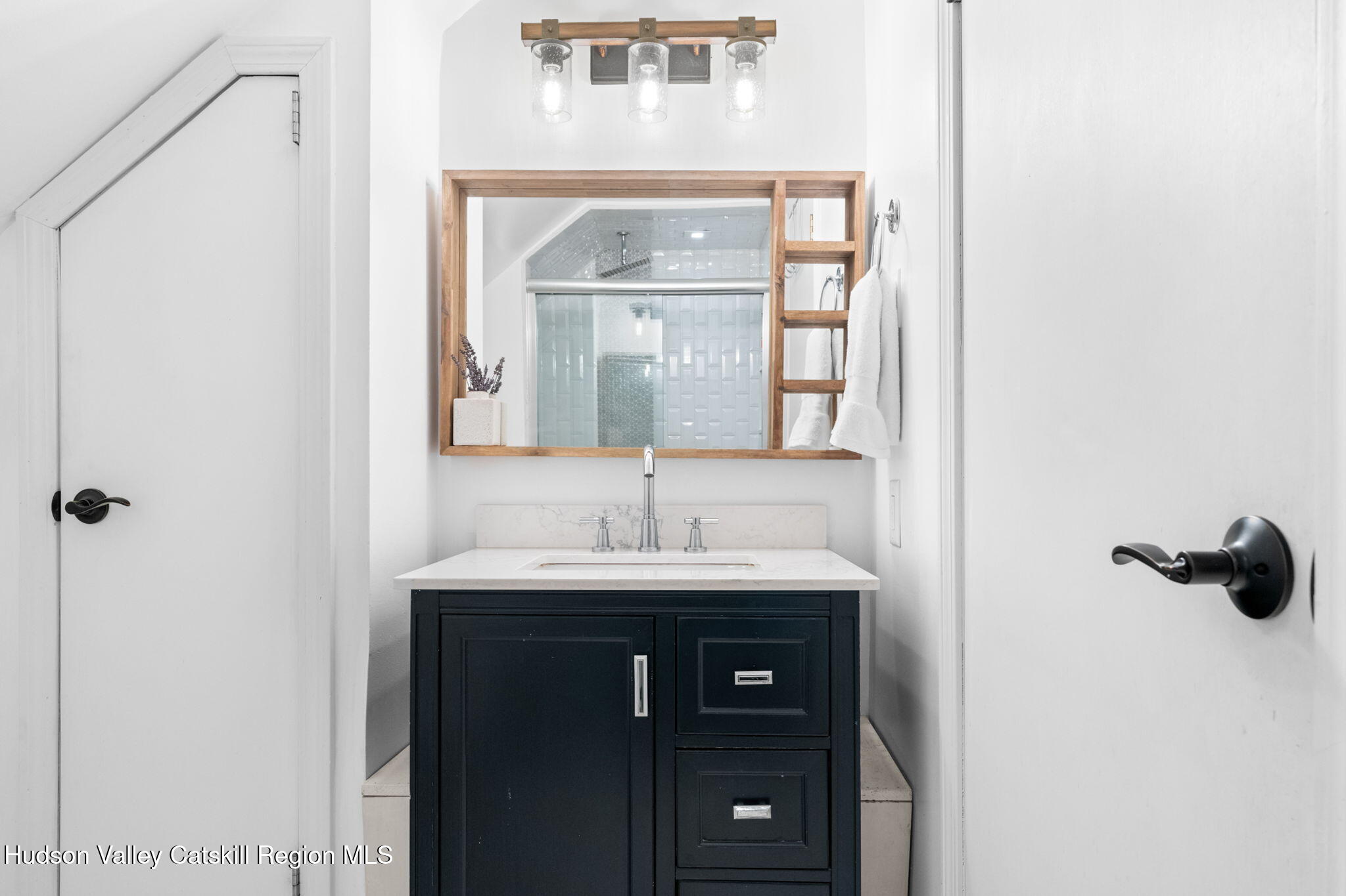 153 Slater Road Windham, NY 12454 - Photo 25 of 38 a bathroom with a sink and a mirror