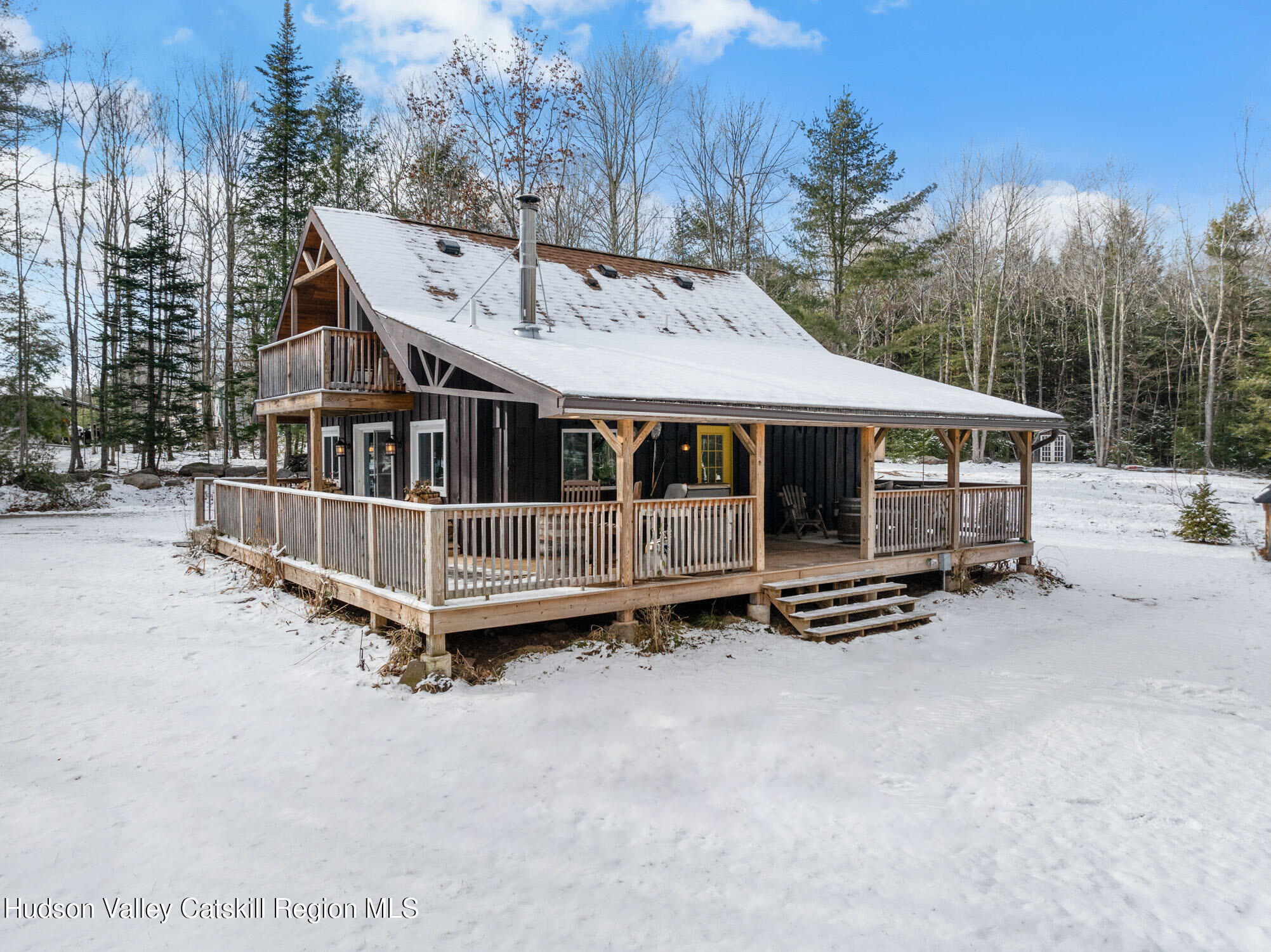 153 Slater Road Windham, NY 12454 - Photo 3 of 38 a view of a house with wooden deck and furniture