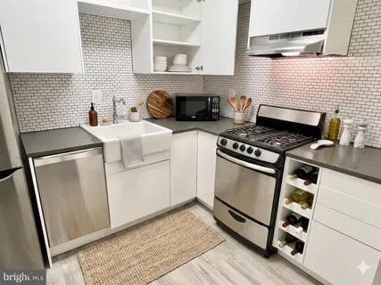 a kitchen with white cabinets and white appliances