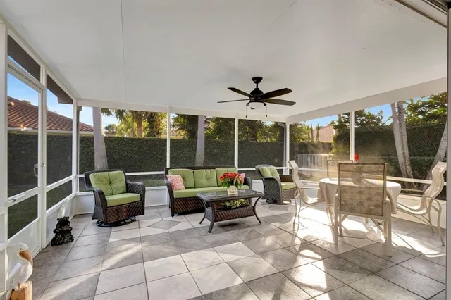 a view of a house with a yard and large tree