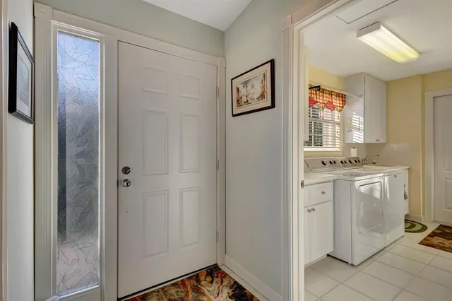 a living room with furniture a window and a flat screen tv