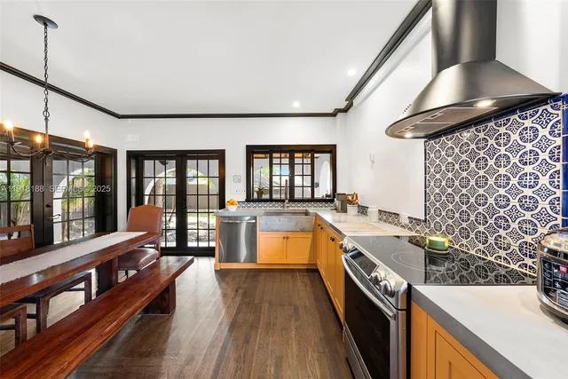 a large kitchen with a large window a sink and stainless steel appliances