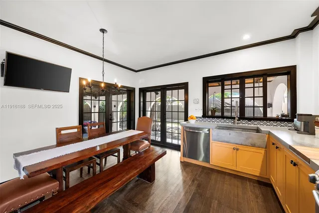 a kitchen with stainless steel appliances granite countertop a sink and wooden floors