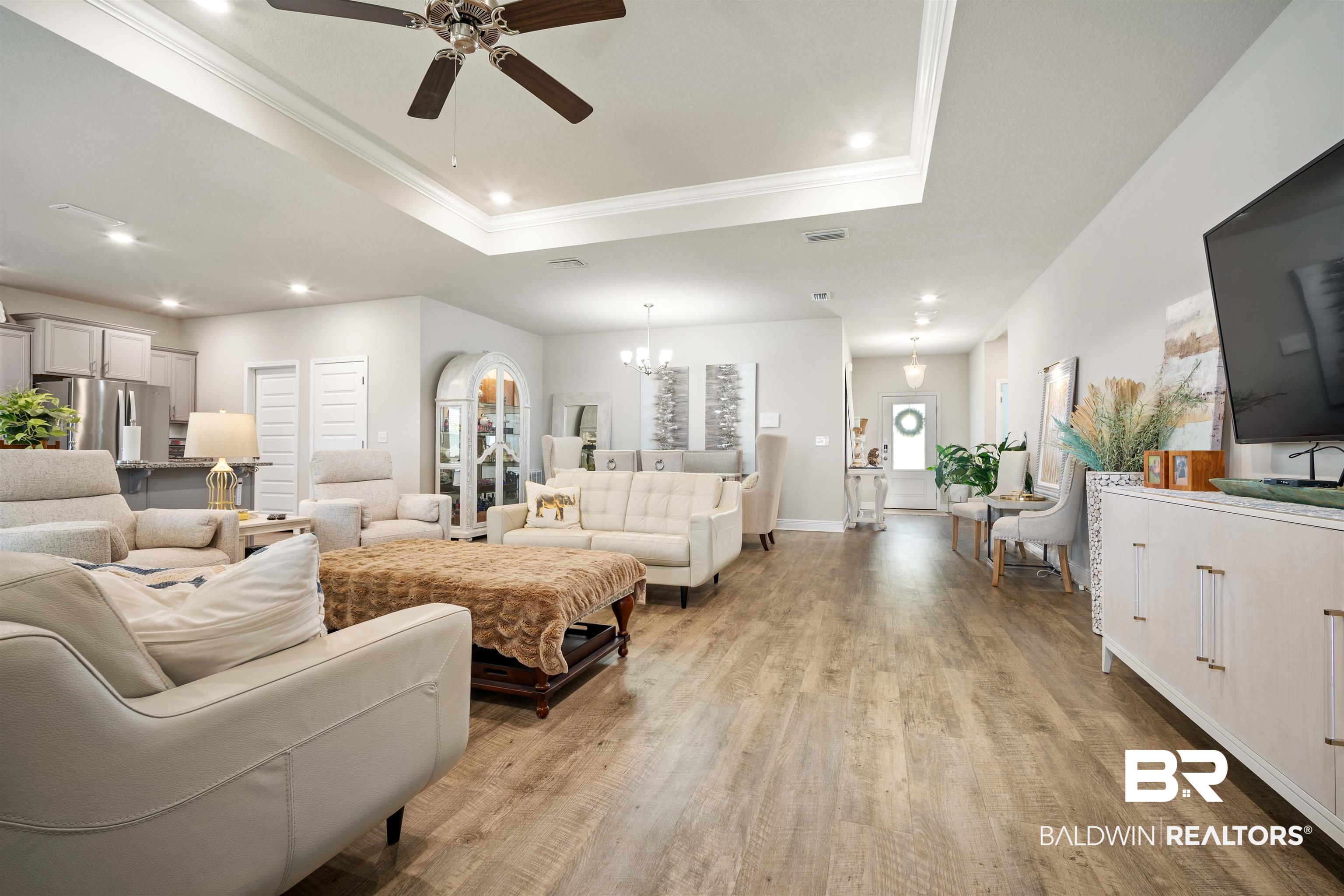 10474 Loamy Avenue Mobile, AL 36695 - Photo 6 of 31 Living room with a tray ceiling, ornamental molding, recessed lighting, light wood-style floors, and a chandelier