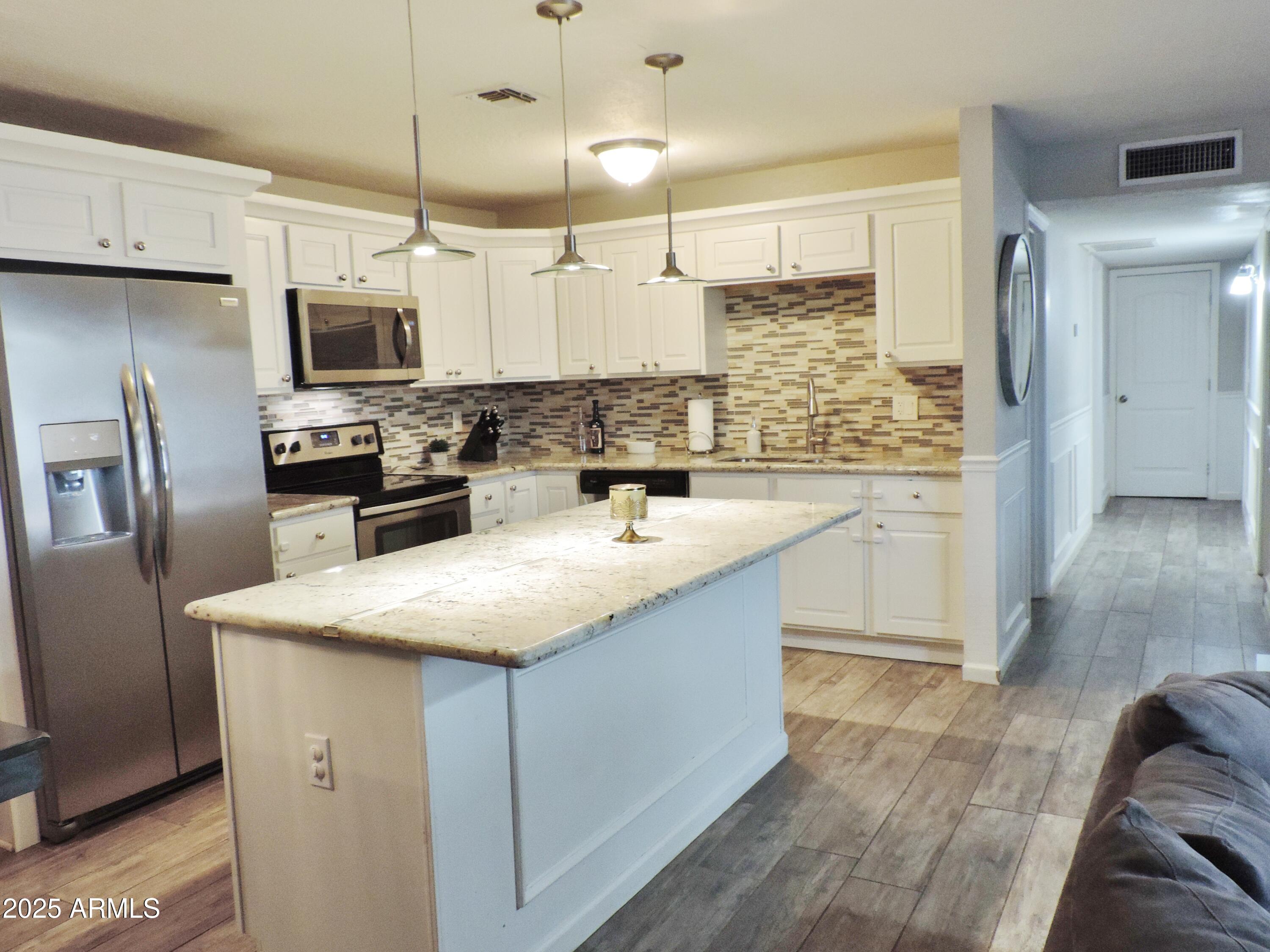764 North Thunderbird Drive Apache Junction, AZ 85120 - Photo 14 of 74 a kitchen with stainless steel appliances granite countertop a sink a stove and refrigerator