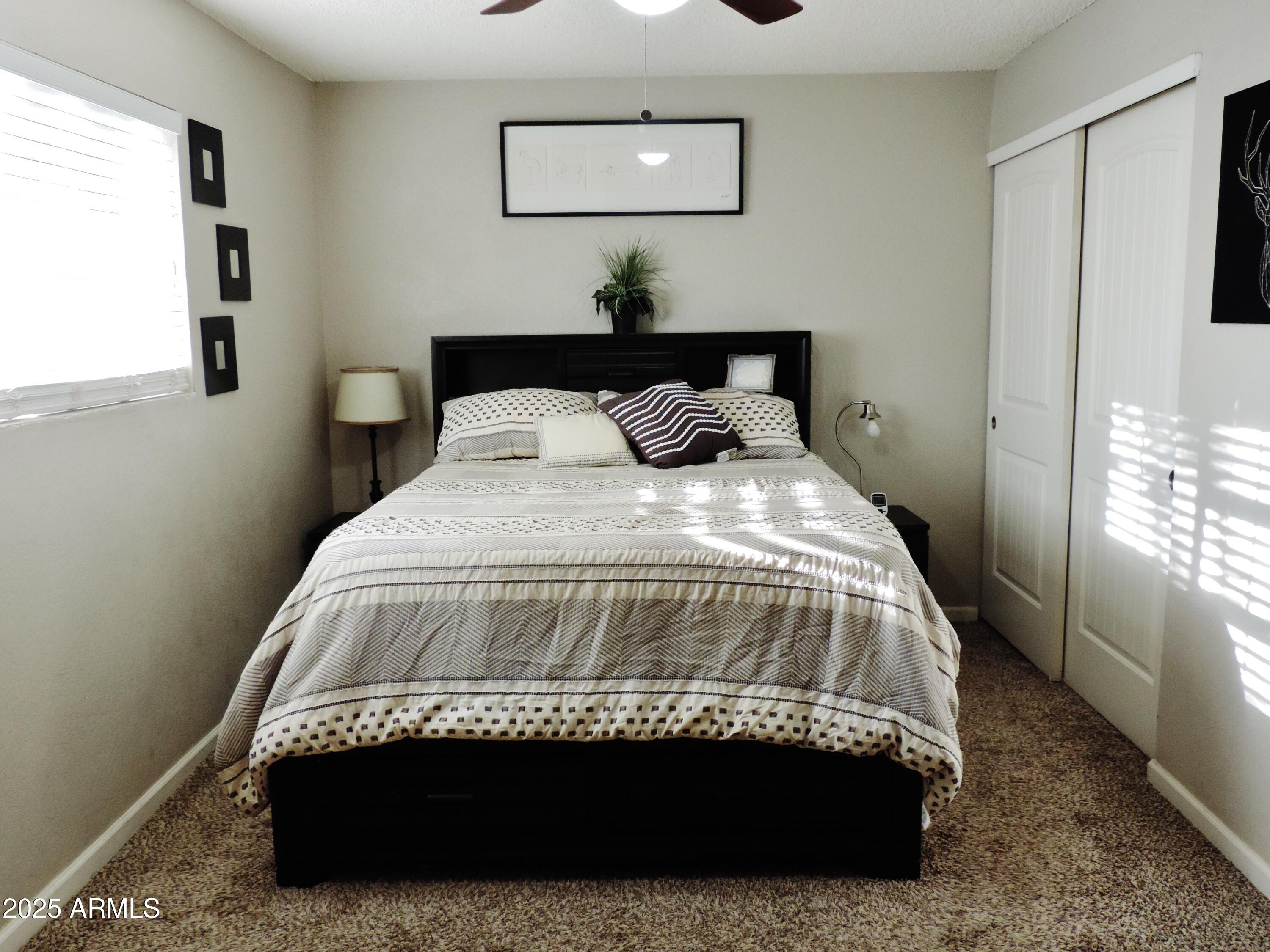 764 North Thunderbird Drive Apache Junction, AZ 85120 - Photo 35 of 74 a bedroom with a bed and a window
