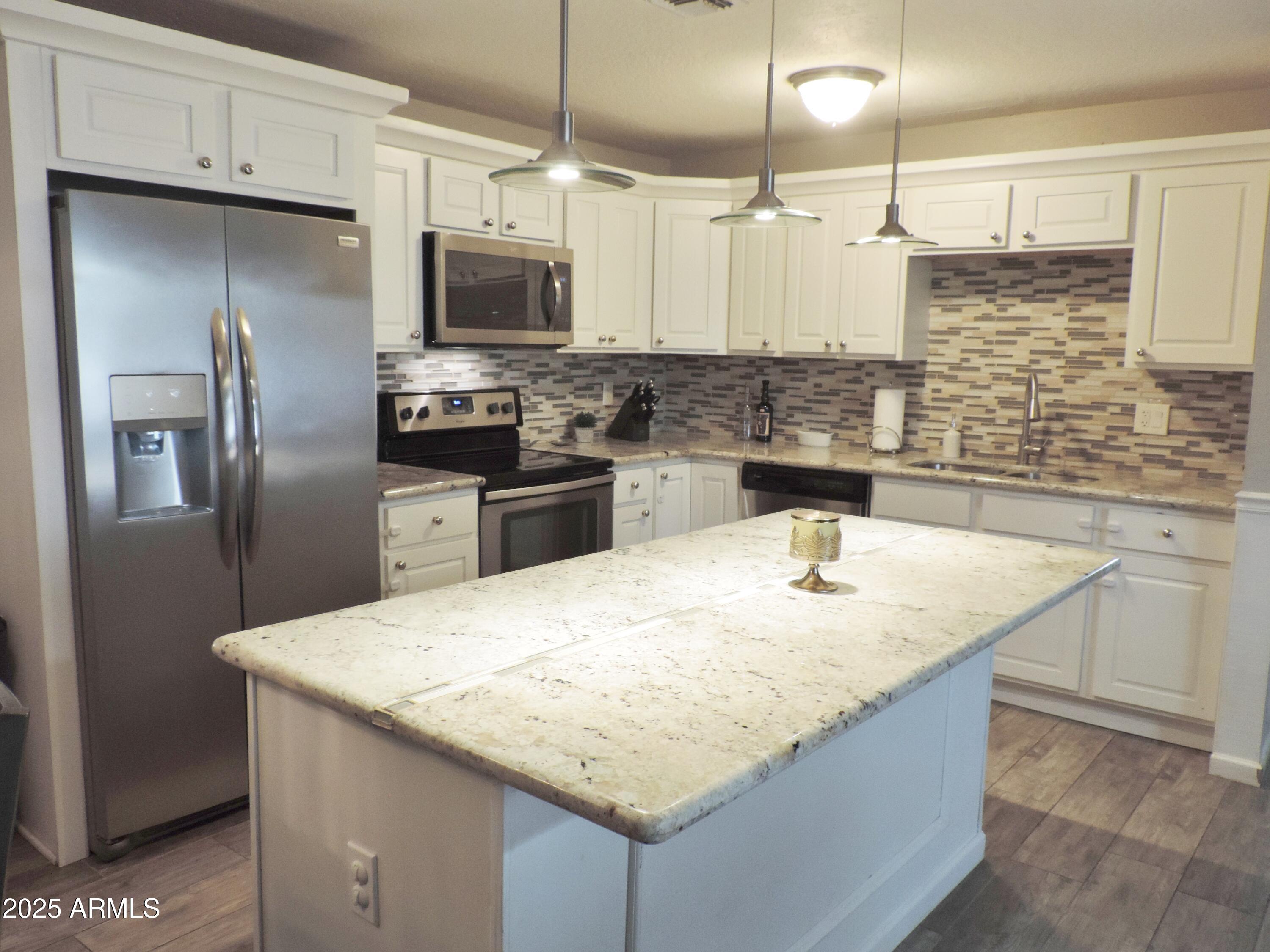 764 North Thunderbird Drive Apache Junction, AZ 85120 - Photo 5 of 74 a kitchen with stainless steel appliances granite countertop a sink a stove and a refrigerator