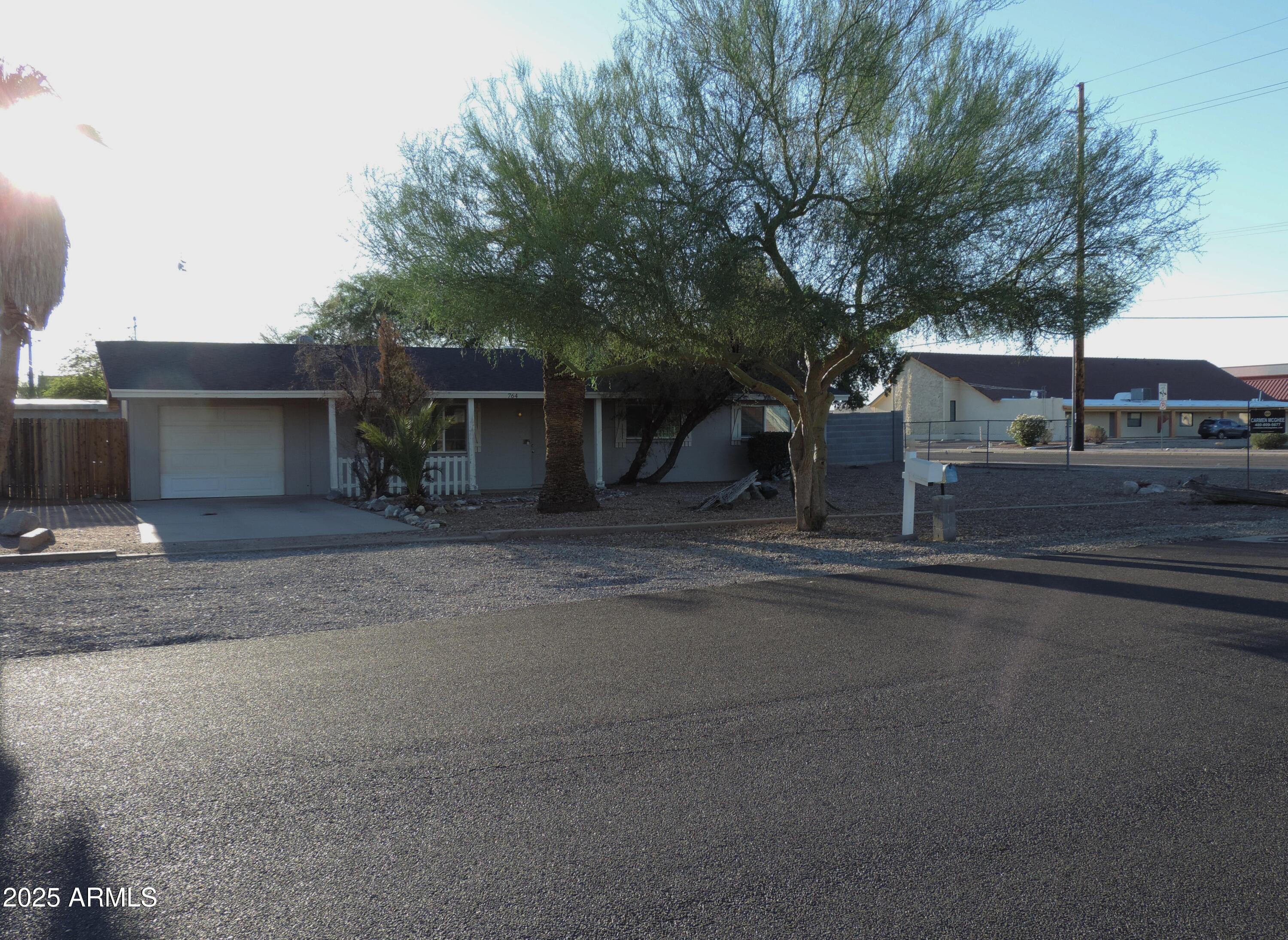 764 North Thunderbird Drive Apache Junction, AZ 85120 - Photo 57 of 74 a front view of a house with a yard and garage