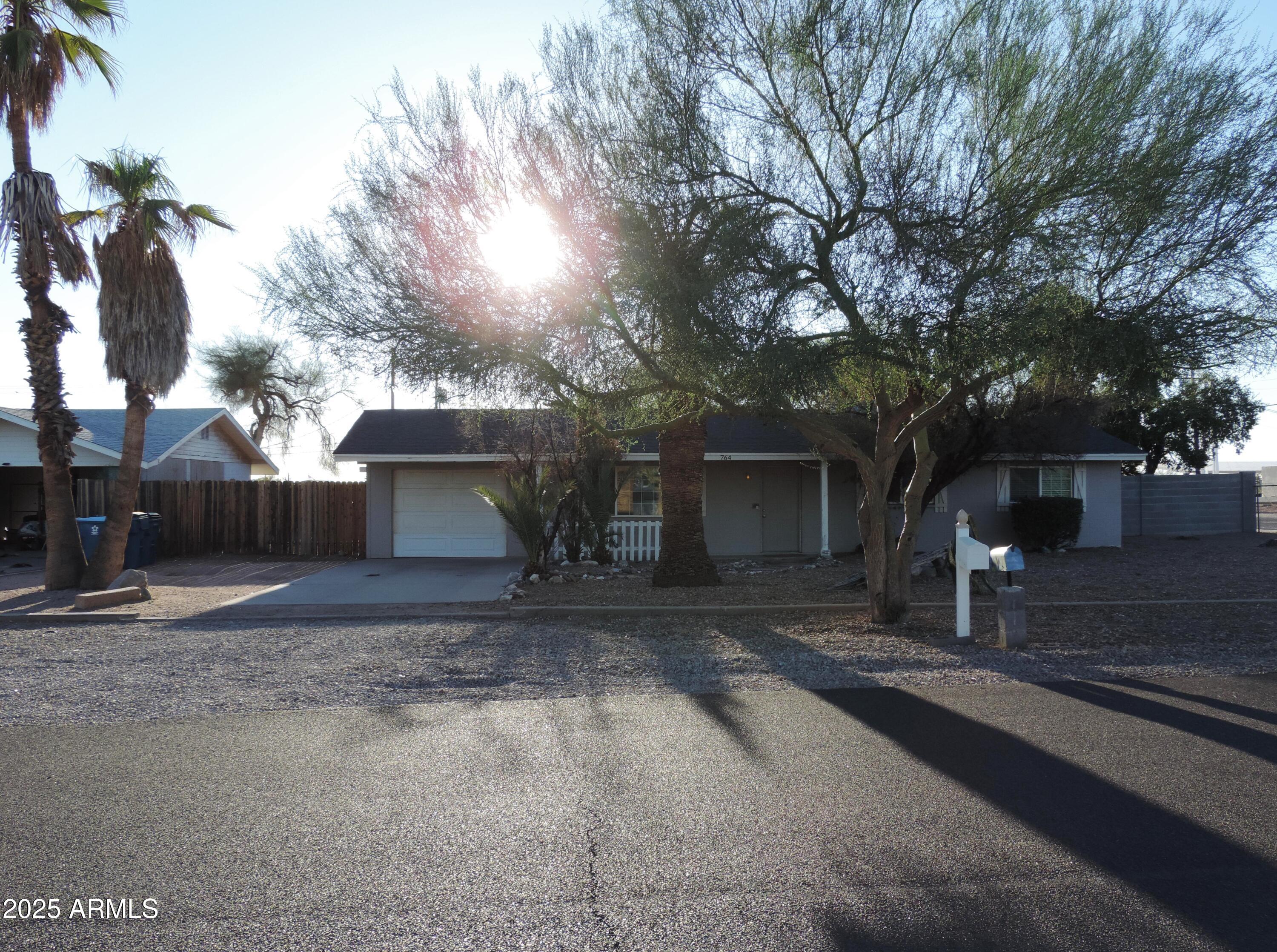 764 North Thunderbird Drive Apache Junction, AZ 85120 - Photo 59 of 74 a front view of a house with a yard and garage