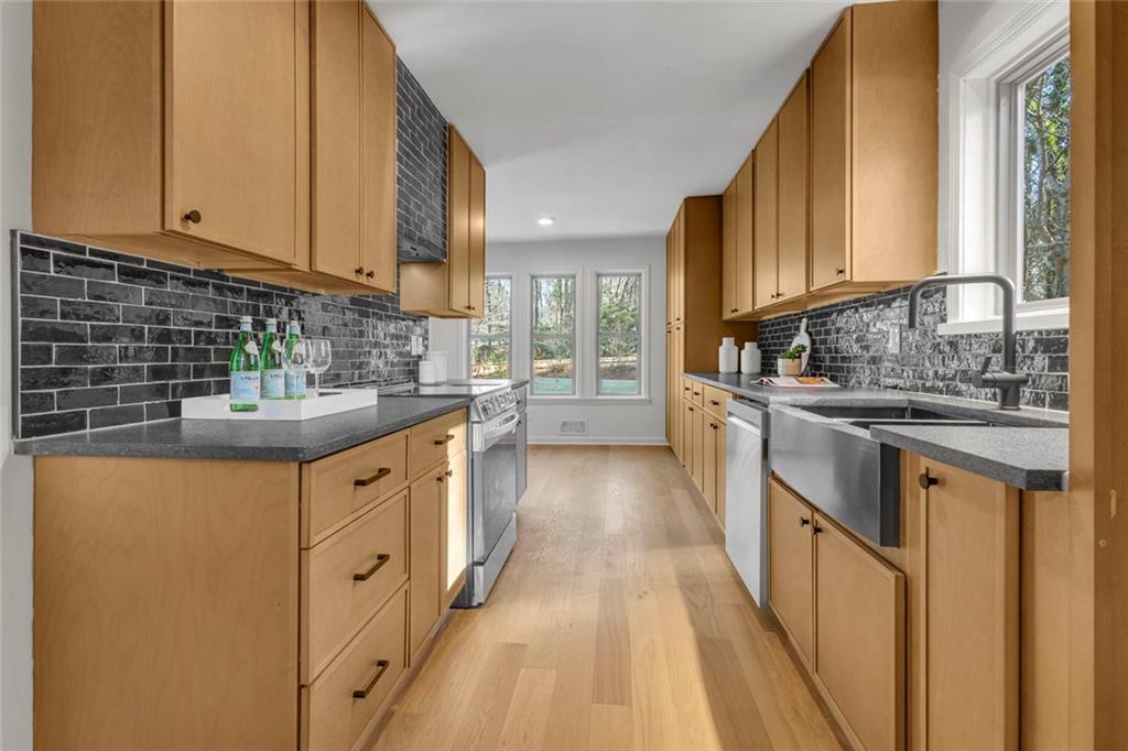 260 Devilla Trace Fayetteville, GA 30214 - Photo 12 of 47 a kitchen with stainless steel appliances granite countertop a sink stove and cabinets