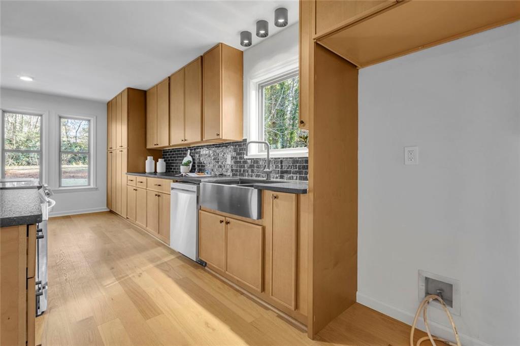 260 Devilla Trace Fayetteville, GA 30214 - Photo 13 of 47 a kitchen with stainless steel appliances granite countertop a sink and a stove top oven