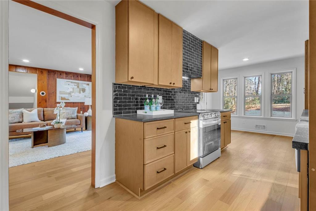 260 Devilla Trace Fayetteville, GA 30214 - Photo 15 of 47 a kitchen with white cabinets and wooden floor